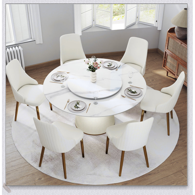 Table de salle à manger ronde moderne en pierre artificielle blanche avec plateau tournant et six chaises, idéale pour les réunions élégantes et les repas de famille