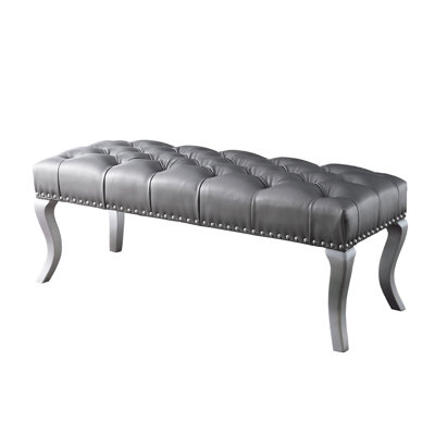 Banc capitonné en tissu avec garniture cloutée