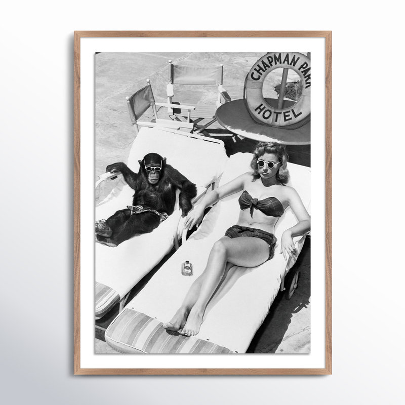 Woman Sunbathing With Chimpanzee by Getty Images, Rustic Walnut Framed, 24" H x 18" W