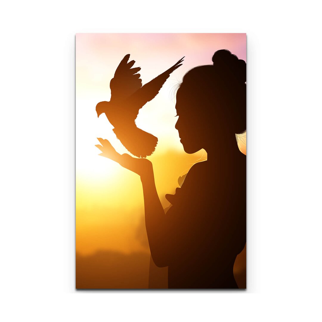 Leinwandbild Silhouette einer Frau mit Taube