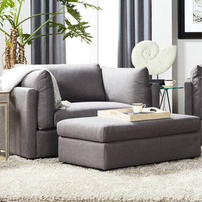 Chaise rembourrée gris carbone pour salon profond et serein en tissu chic