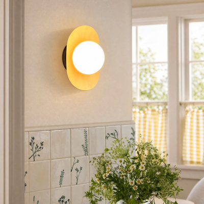 Applique murale en fer Dayanira avec abat-jour globe en verre opalin et plaque dorée courbée