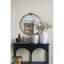Miroir mural rond avec finition dorée et écusson décoratif