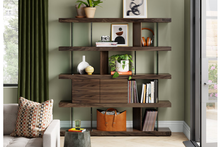 wood bookcase with houseplants, magazines, books, and vases