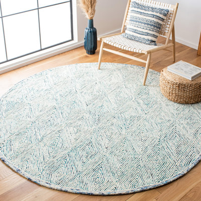 Tapis géométrique bleu / ivoire en laine touffetée à la main de la personne