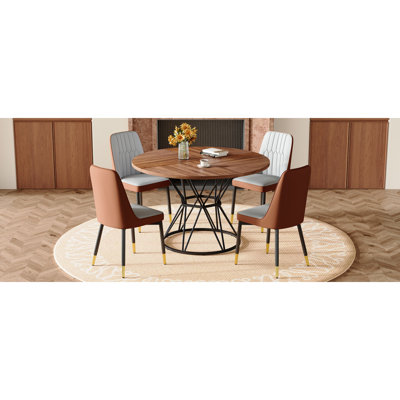 Table And Chair Set.A Circular Walnut MDF Dining Table With A Diameter Of 47.3 Inches,Black Hourglass Shaped Metal Brackets.Paired With 4 Brown And Light Gray Spliced Color PU Dining Chairs.