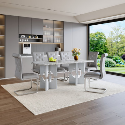 Ensemble de table de salle à manger moderne 7 pièces, table en bois aggloméré gris imitation marbre avec 6 chaises de salle à manger rembourrées grises, pieds de traîneau en métal argenté, meubles de cuisine et de salle à manger contemporains pour la famille et les invités