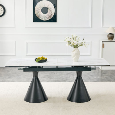 Extendable Stone-Top Dining Table: White marble-patterned tabletop with black tapered metal legs. A modern, luxury-inspired rectangular dining table f