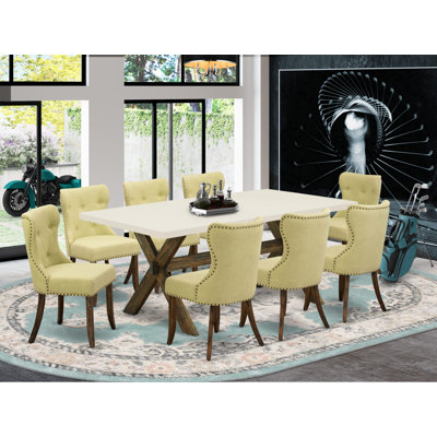 L'ensemble de mobilier de salle à manger 9 pièces comprend une table de salle à manger rectangulaire avec des pieds en X et 8 chaises rembourrées en tissu Linelight, finition jacobine patinée