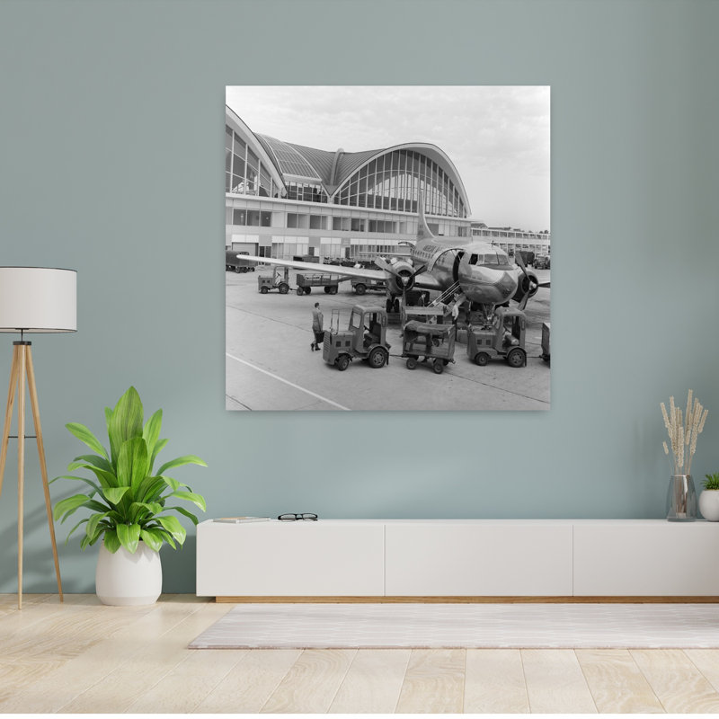 1950s 1960s PROPELLER AIRPLANE ON AIRPORT TARMAC IN FRONT OF TERMINAL WITH MODERN ARCHED WINDOWS ST. LOUIS MISSOURI USA by C. S. Bauer - Wrapped Canvas Print