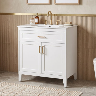Meuble-lavabo minimaliste sur pied avec lavabo en céramique, tiroir basculant, tablette réglable et portes à fermeture douce.