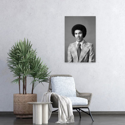 1970S Serious African American Man Portrait With Afro Hair Style Looking At Camera Wearing Plaid Jacket With Very Wide Lapels Classic Retro Vintage...