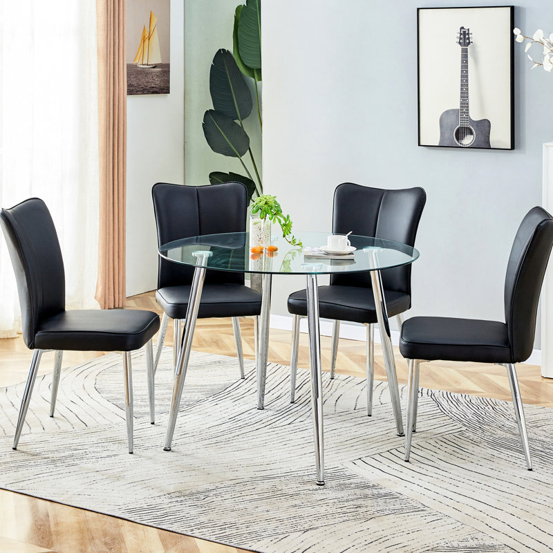 Verre transparent et salle à manger en métal argenté pour 4 personnes: table avec pieds en polyuréthane et chaises noires en polyuréthane