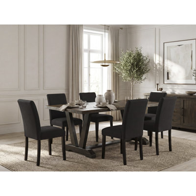 7 Piece Dinette Set consists of a Distressed Jacobean Rectangle Dining Room Table with V-Legs and 6 Black Linen Fabric Upholstered Chairs, Wire-Brushed Black Finish