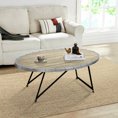 Table basse en chêne vieilli et métal noir patiné, forme ovale pour table de salon élégante avec base