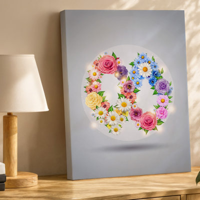 La toile crée une conception circulaire vibrante mettant en vedette un symbole luxuriant infini, composé d'un tableau de fleurs colorées, y compris un art mural sur toile