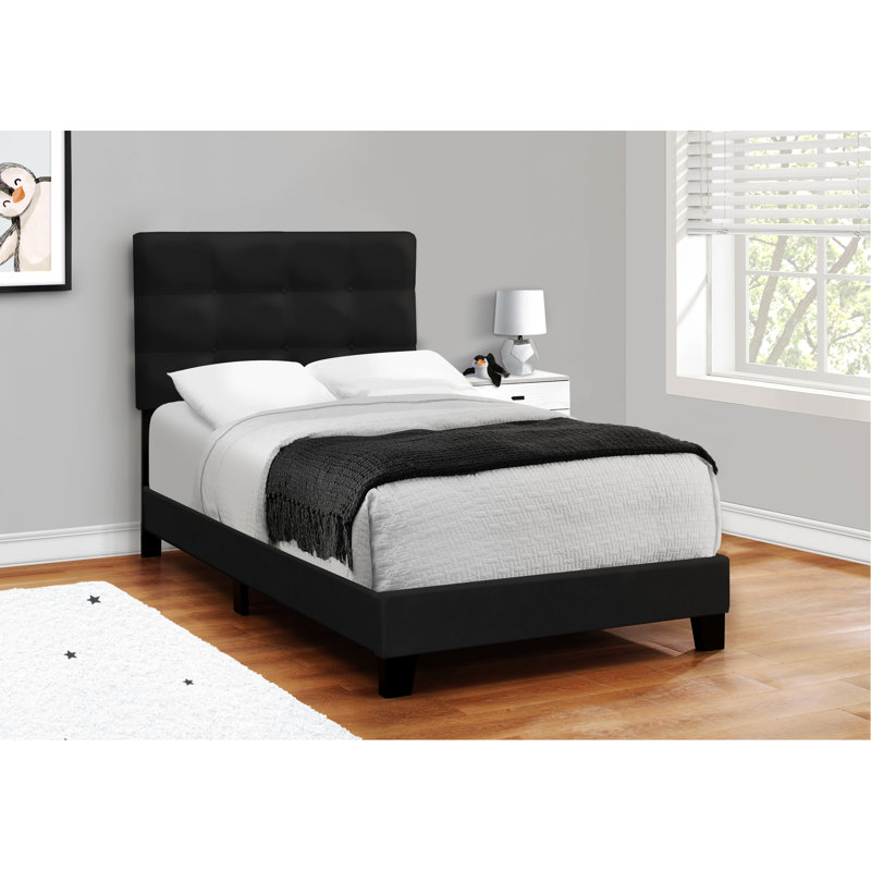 Élégant lit simple revêtu de velours noir pour le cadre transitionnel d'une chambre d'ado