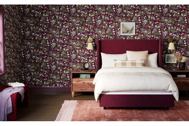 Bedroom with purple floral wallpaper, a purple upholstered bed, white bedding, and a pink rug.