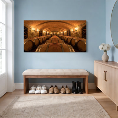 Ensemble de 1 tableau sur toile représentant une cave à vin avec tonneaux en bois et murs en pierre.