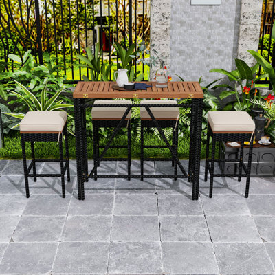 Ensemble repas d'extérieur 5 pièces avec table pliable en bois d'acacia, tabourets en osier et coussins pour la cour