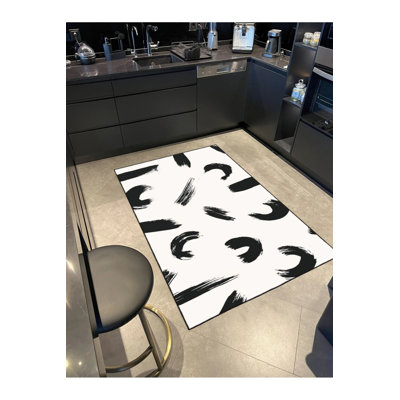 Base tissée à motif noir tacheté et tapis lavable