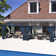 Modern Outdoor Slant-Top Hardtop Gazebo With Black Metal Frame And Curtains