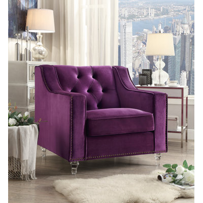 Fauteuil club en velours capitonné en velours