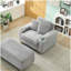 Canapé simple en velours côtelé gris avec un oreiller, deux coussins décoratifs, un repose-pieds et deux espaces de rangement.