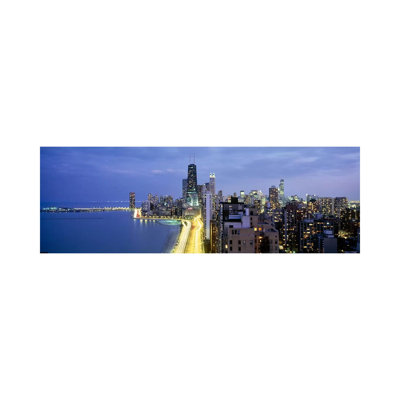 Skyscrapers Lit Up At The Waterfront, Lake Shore Drive, Chicago, Cook County, Illinois, USA by Panoramic Images - Wrapped Canvas Panoramic Print