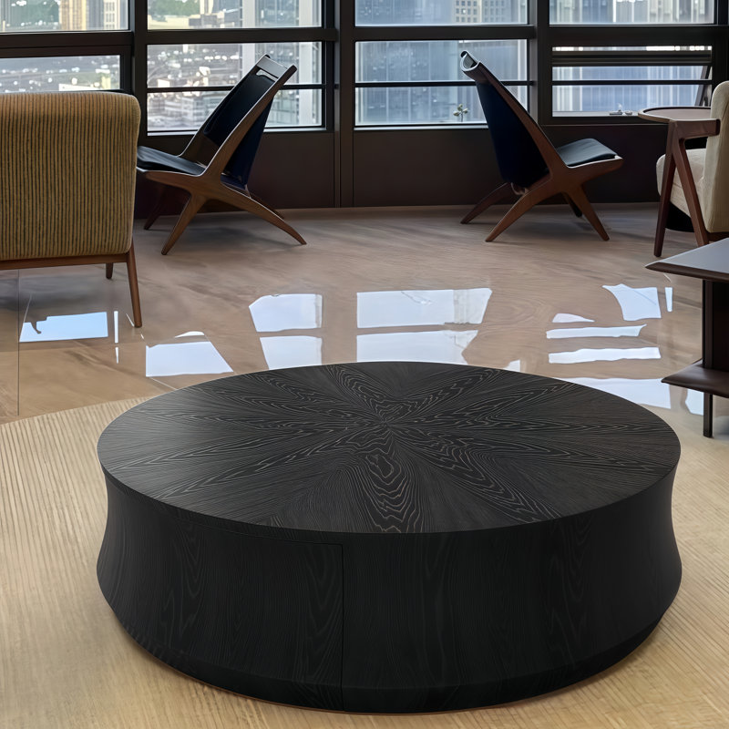 Table basse ronde noire avec un grand tiroir