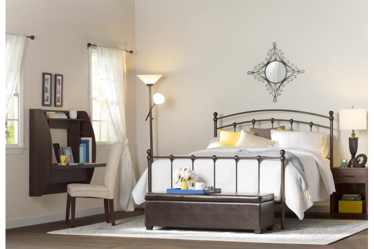 transitional-style bedroom with a wall-mounted, floating desk and a white upholstered chair