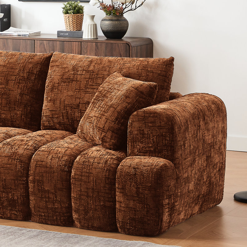 Chenille orange à 4 places en forme de L avec un design segmenté, une structure à ressorts ensachés et un arrangement polyvalent pour les espaces de vie.