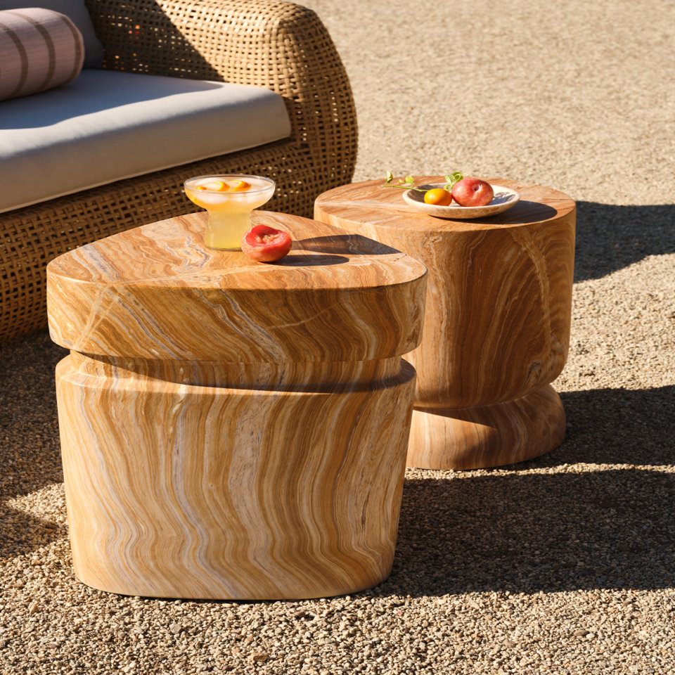 Two outdoor side tables made of light brown wood.