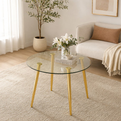A glass tabletop with a diameter of 40 inches and a modern minimalist circular dining table with electroplated golden metal legs.Suitable for living rooms, and conference rooms.W1151S02857(Table only)