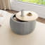 Repose-pieds rond avec rangement Dariyan-944897203