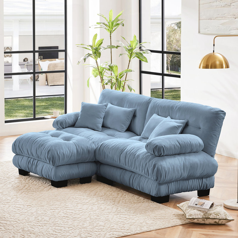 Canapé modulaire en chenille pour le salon avec plusieurs coussins et repose-pieds