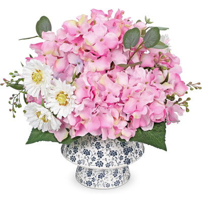Bouquet de fleurs artificielles roses dans un vase en céramique