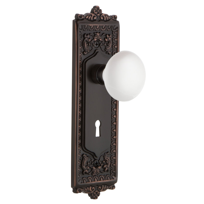 Egg & Dart Plate with Decorative Keyhole and White Porcelain Door Knob, Timeless Bronze, 2-3/8”