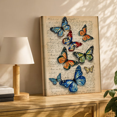 Toile, arrangement vibrant de papillons variés dans des tons de bleu, art mural orange rouge et vert délicatement perché sur toile de fond