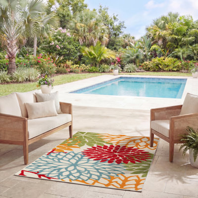 Tapis intérieur / extérieur vert / rouge / orange à motif floral Miraloma