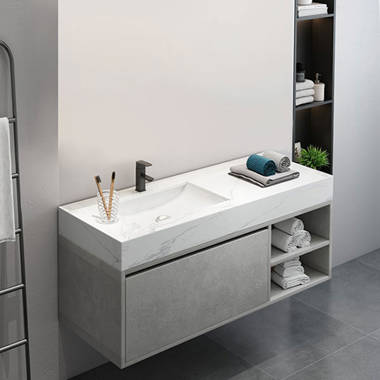 White modular shelves are mounted beside a drop-in bathtub fitted with  white horizontal surround tiles…