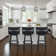 Deherrera Modern Swivel Counter or Bar Stool with Open Low Back and Footrest in Metal and Faux Leather