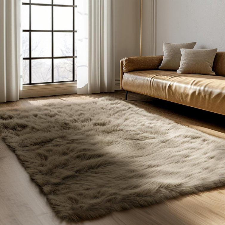 Blakes Solid Color Handmade Faux Sheepskin Area Rug in Beige