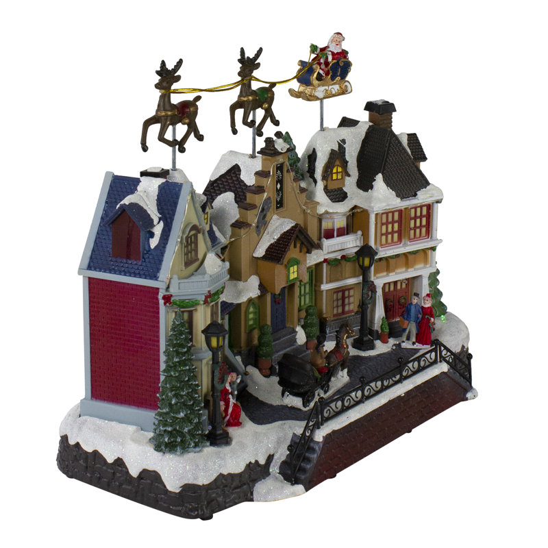 16" White and Brown LED Lighted and Animated Christmas Village with Flying Sleigh Tabletop Decor