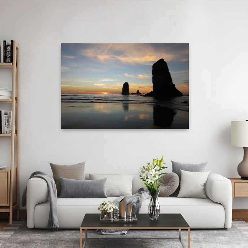 Silhouettes Of Rock Formations At Sunset At Cannon Beach Oregon USA by Dan Merkel - Wrapped Canvas Print