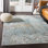Tapis bleu sarcelle / beurre à motif abstrait Aman