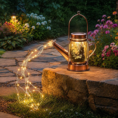 A solar Watering Can lantern with Cascading Lights provides outdoor garden decor for yards, patios, backyards, or porches and is suited as a gift for women, Mom, or Grandma.