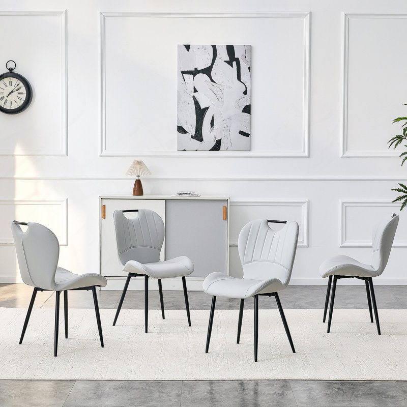 Ensemble de 4 chaises de salle à manger en polyuréthane gris clair avec poignée intégrée. Cadre en métal noir, pieds réglables. Chaises de salle à manger à domicile avec coussin confortable extra-large, polyvalent pour de multiples cas de figure.