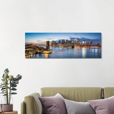 Elevated View Of The Manhattan Skyline With Brooklyn Bridge by Jan Becke - Wrapped Canvas Panoramic Print