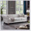 Canapé Chesterfield en tissu de lin beige avec un design classique et des sièges confortables, parfait pour les salons élégants